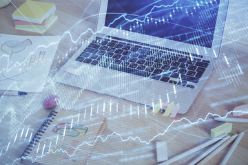 Financial chart drawing and table with computer on background. Multi exposure. Concept of international markets.