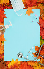 Flu and cold season frame on blue with fall leaves. Flu season or second wave. Face protective...