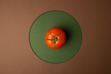 red tomato on green background