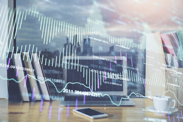 Financial graph colorful drawing and table with computer on background. Double exposure. Concept of international markets.