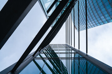 Triangular abstract view on modern office building with sky