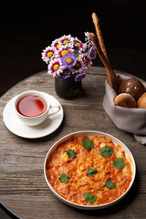 Fried eggs with tomatoes. Omelette on breakfast table