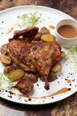 Grilled chicken Tabaka with baked potatoes and with sauce