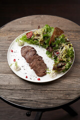 Grilled beef steak with fresh salad. Roasted meat steak