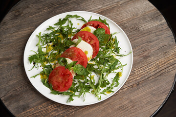 Italian caprese salad with sliced tomatoes, mozzarella