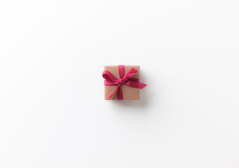 Top view present gift box with ribbon on the white table background. Merry christmas and Happy new year theme.
