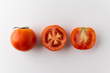 Ripe Tomato Sliced in different ways and arranging. Top view fresh tomato on isolated background. Healthy vegetables and food.