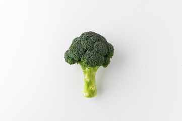 Fresh Healthy vegetables and food. One Raw broccoli put on white table background.