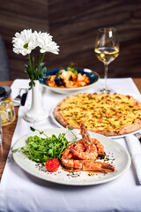Fried shrimps and pizza on a table