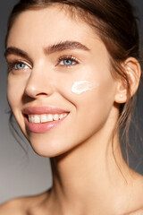 Beauty and skin care concept. Face of woman with facial mask, moisturizer on natural ingradients, nourish and hydrate face with collagen and aloe vera, treating inflammations and smiling