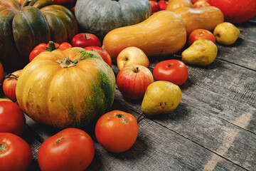 Pumpkins and red apples on wooden background