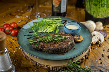 Pepper beef steak with rosemary and greens