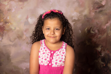 Small girl with flowing and pink tiara and curly hair with an abstract background, Renaissance...