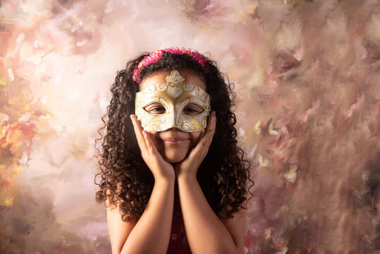 Venetian Mask, small girl wearing a Venetian mask with an abstract background, Renaissance style photo, selective focus.
