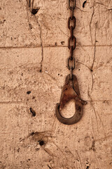 Closeup shot of an old rusty shackle on wall