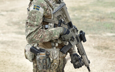 Fototapeta premium Soldier with assault rifle and flag of Sweden on military uniform. Collage.