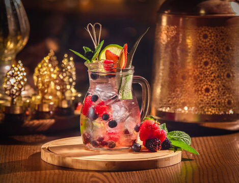 Various lemonades in mason jars with orange lime lemon otange strawberries and fresh fruit fruits