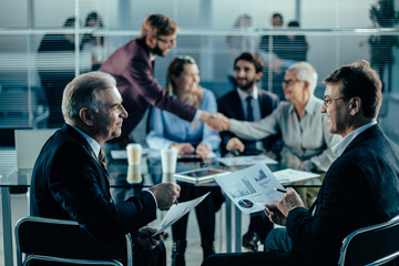 business partners discussing the terms of the financial agreement.