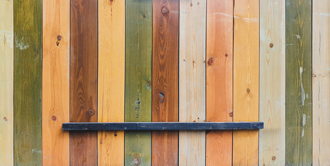 Wooden background from multi-colored boards. Wall or fence, vintage.