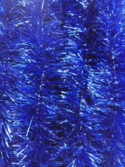 Christmas, New Year, blue garlands for decoration for the holiday. Tinsel is a New Year's garland, a symbol of the new year, a true decoration of any holiday and a joy for children and adults.