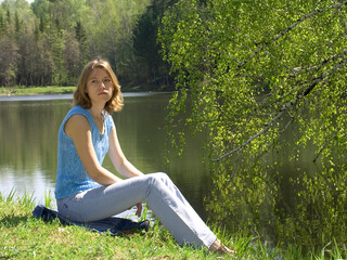 Girl siting near pond