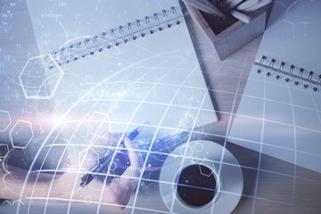 Multi exposure of hands making notes with world map hologram and data theme icons. Concept of global data.