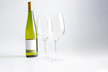 Wine bottle and two wine glasses. Wine bottle against a white background