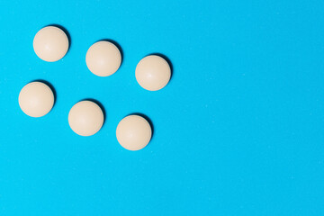 round white tablets on a blue table .