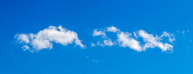 Fototapeta na wymiar Blue sky with white clouds in sunny weather, panorama