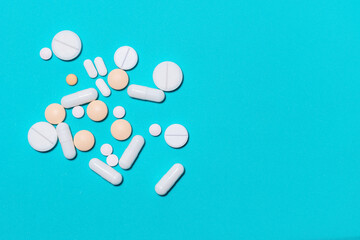 tablets, vitamins and dietary supplements on a blue background .