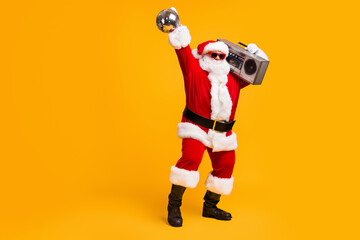 Full length photo of cool santa claus with grey beard listen x-mas christmas songs boom box hold...