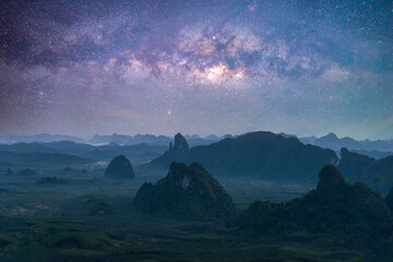 Landscape view of the mountains and colorful milky way galaxy with stars space in night sky....