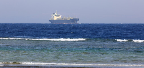 a cargo ship is sailing at sea