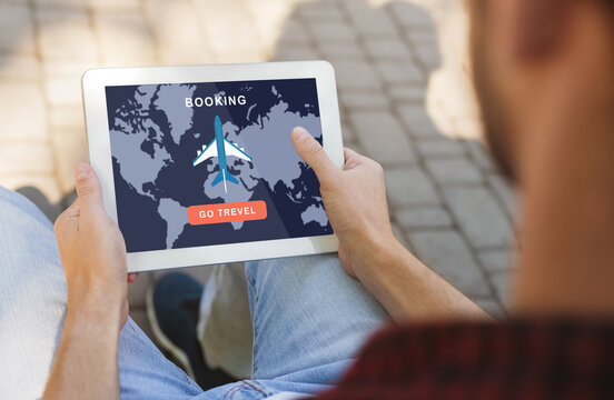 Booking go travel. Guy use tablet with mobile map and airplane application for buying tickets on screen