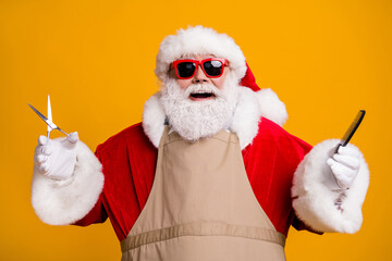 Close-up portrait of nice attractive cheerful cheery glad grey-haired Santa wearing apron holding...