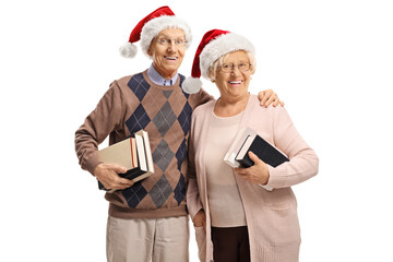 Elderly couple wearing Santa Claus hats and holding books