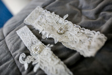 white lace garter for wedding day on bed
