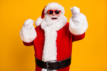 Portrait of his he nice attractive cheerful cheery glad Santa father celebrating newyear having fun rejoicing isolated over bright vivid shine vibrant yellow color background