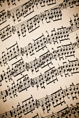 Obraz premium Vintage yellow paper sheet with musical notes.