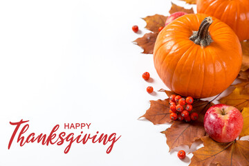 Thanksgiving greetings. Dry yellow leaves, pumpkins, berries and apples on a white background, top...
