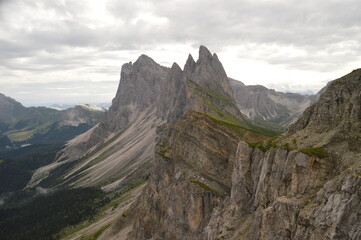 Fototapeta premium Hiking on the dramatic mountain ridge of Seceda in South Tyrol's Dolomites, Northern Italy