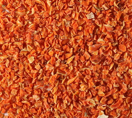 Dry chopped carrot pieces, vegetable slices background and texture