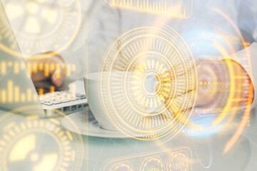 Technology theme hologram with man working on computer on background. High tech concept. Multi exposure.