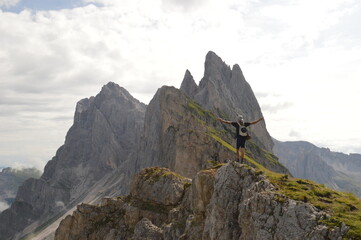 Hiking on the dramatic mountain ridge of Seceda in South Tyrol's Dolomites, Northern Italy