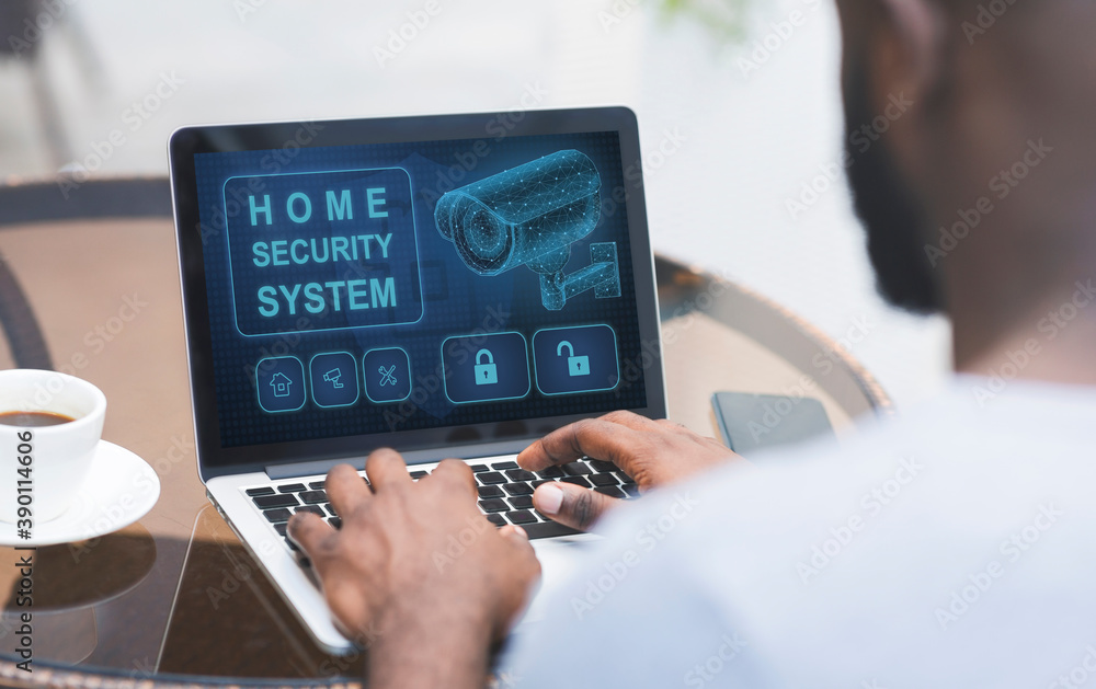 Aufkleber man using his laptop with home security application