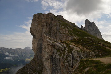 Hiking on the dramatic mountain ridge of Seceda in South Tyrol's Dolomites, Northern Italy