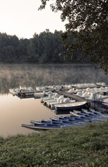  pedal boats and cayak canoe in morning fog by Solina Lake in Bieszczady National Park
