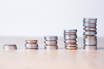 Stock market investment and business profit concept, Increasing Silver and bronze coins stacking chart on table.