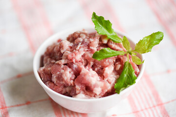 Mincemeat , minced or ground meat raw pork with basil leaf on bowl Ground Pork