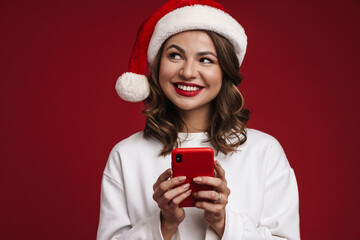 Happy young woman in christmas santa hat